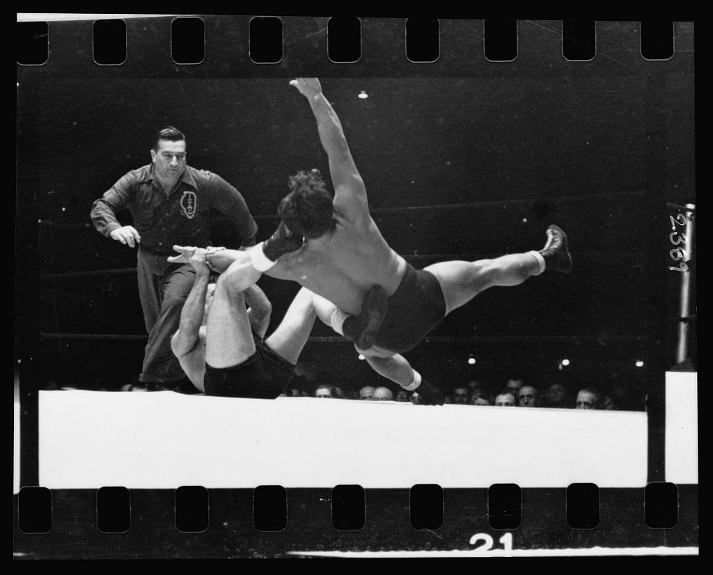 Two men wrestling with a referee nearby. Stanley Kubrick.