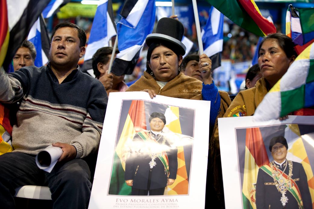 Activists and indigenous community members hold pictures of Evo Morales in Cochabamba, Bolivia in July 2013. Cancillería del Ecuador / Flickr