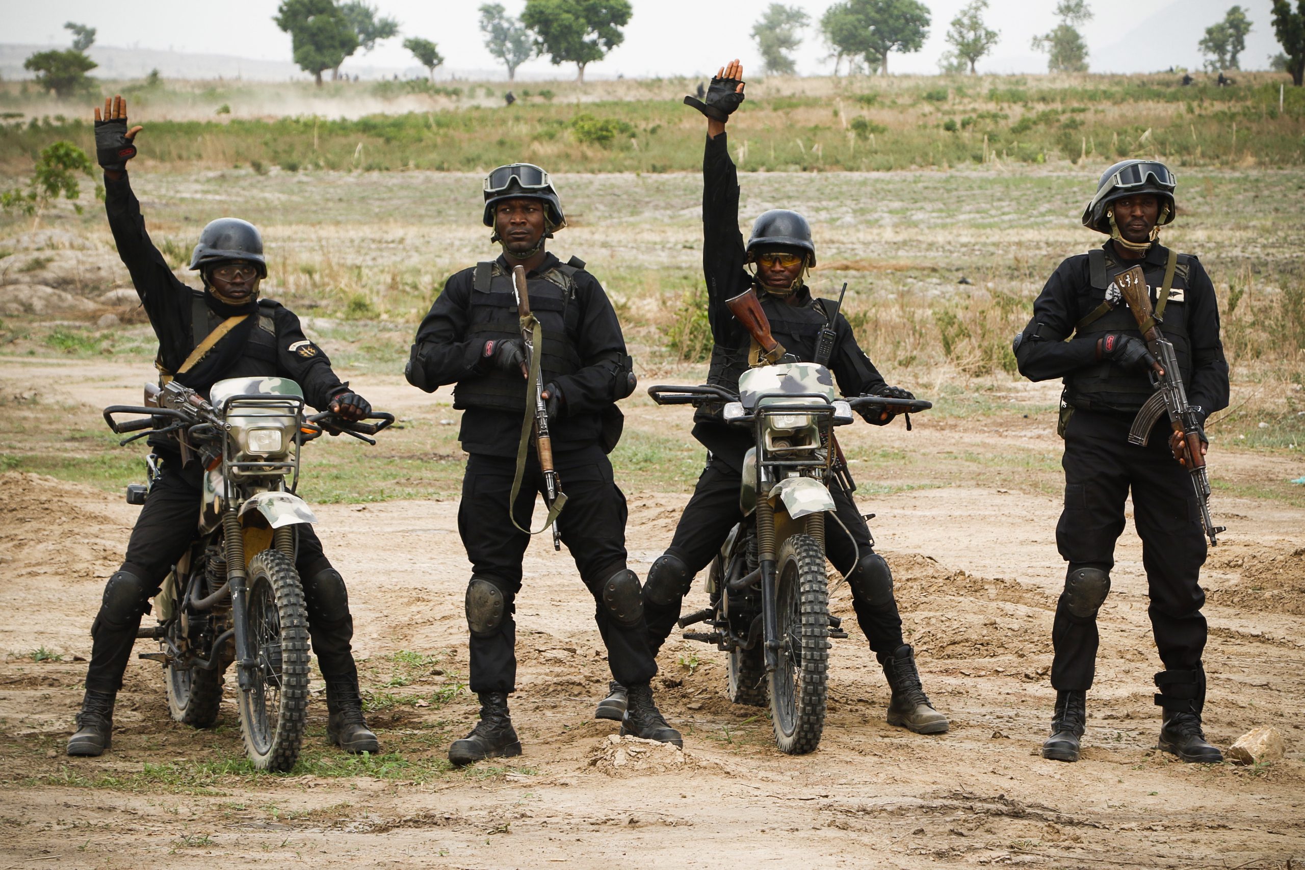 Nigerian soldiers in black tactical gear stand with motorcycles during a demonstration at the African Land Force Summit in Abuja